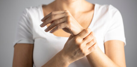 A person holding her wrist in pain.