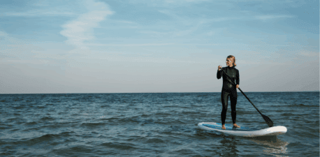 woman on a stand up paddle board on the ocean.