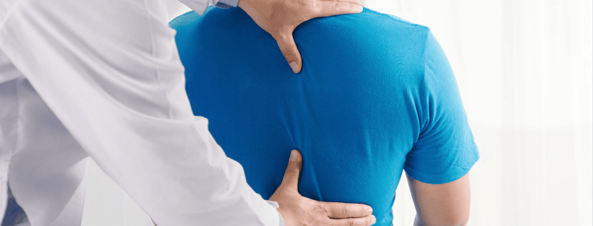 Clinician examining a patient’s back