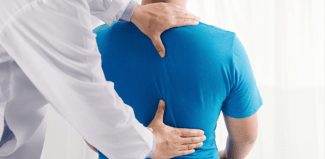 Clinician examining a patient’s back
