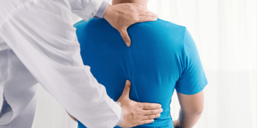 Clinician examining a patient’s back