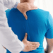 Clinician examining a patient’s back